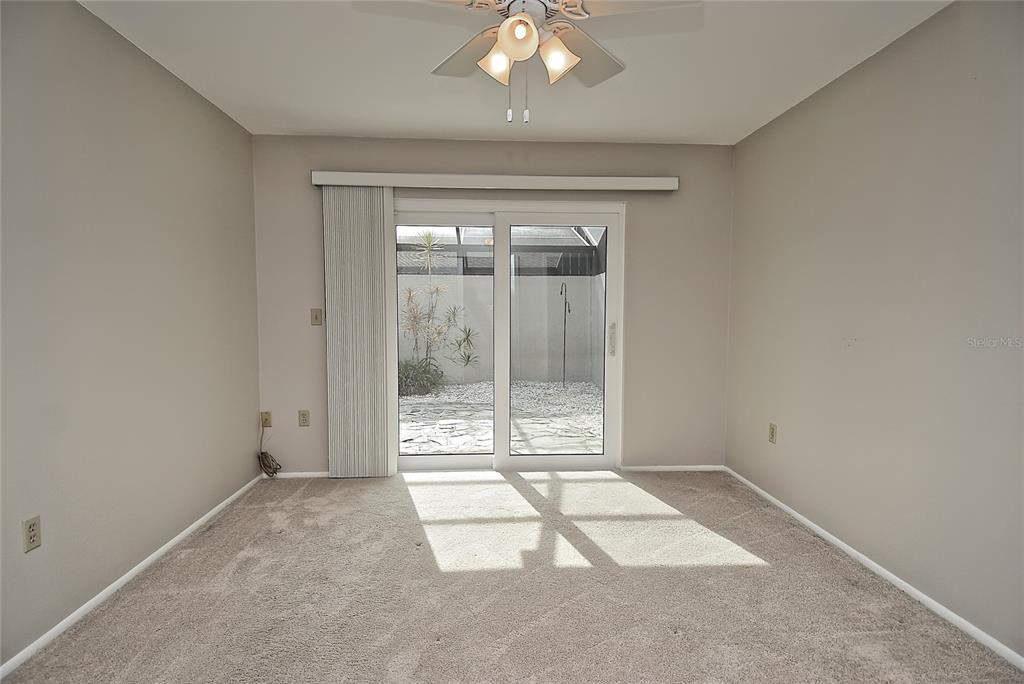4058 Center Pointe Place, Unit 28A Sarasota, FL 34233 - Photo 12 of 24 an empty room with floor to ceiling windows and painted walls