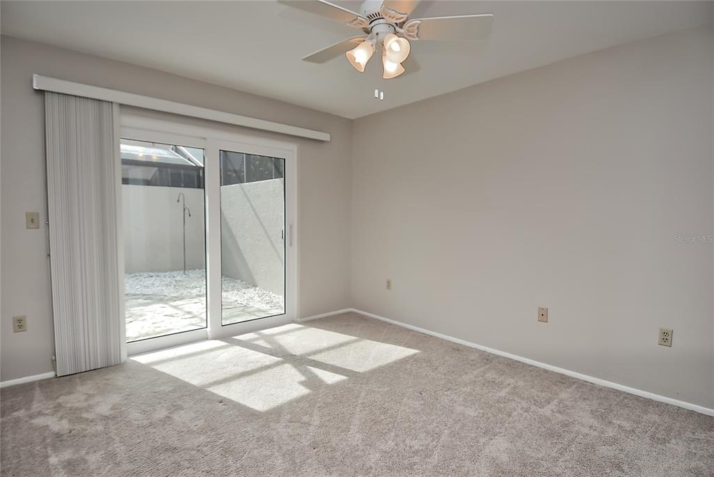 4058 Center Pointe Place, Unit 28A Sarasota, FL 34233 - Photo 13 of 24 an empty room with a ceiling fan and window