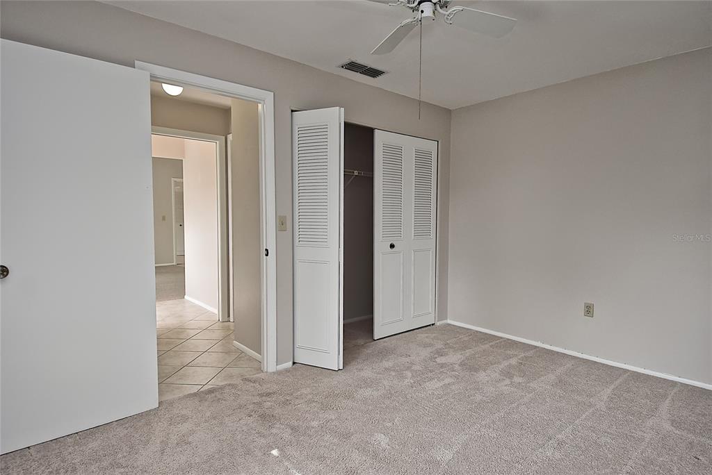 4058 Center Pointe Place, Unit 28A Sarasota, FL 34233 - Photo 14 of 24 an empty room with a ceiling fan and a window