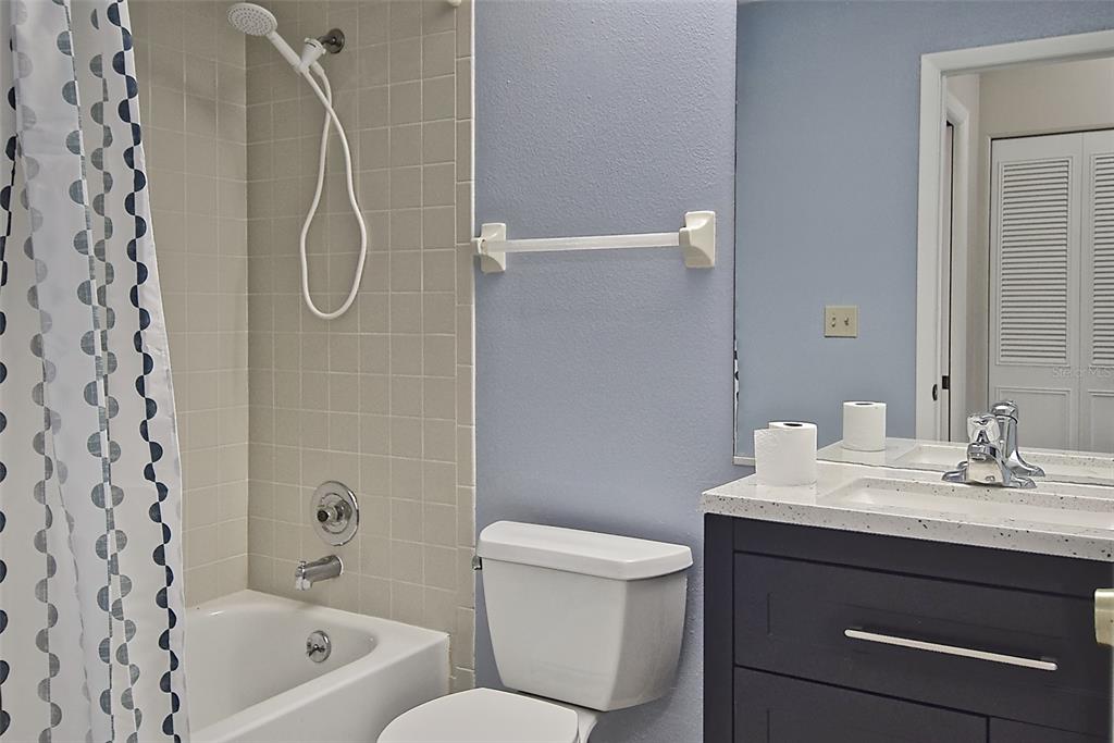 4058 Center Pointe Place, Unit 28A Sarasota, FL 34233 - Photo 18 of 24 a bathroom with a sink a toilet and shower