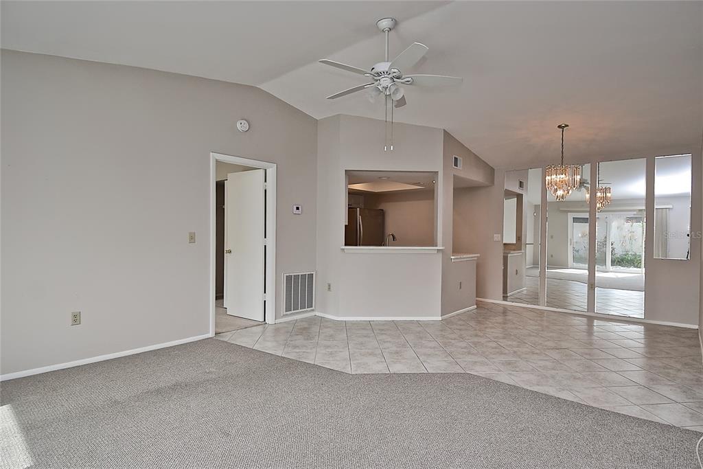 4058 Center Pointe Place, Unit 28A Sarasota, FL 34233 - Photo 3 of 24 a view of a livingroom with wooden floor and a kitchen