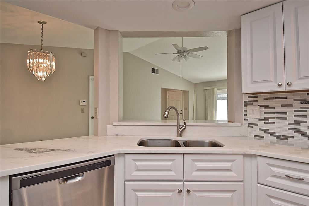 4058 Center Pointe Place, Unit 28A Sarasota, FL 34233 - Photo 8 of 24 a kitchen with a sink and a window