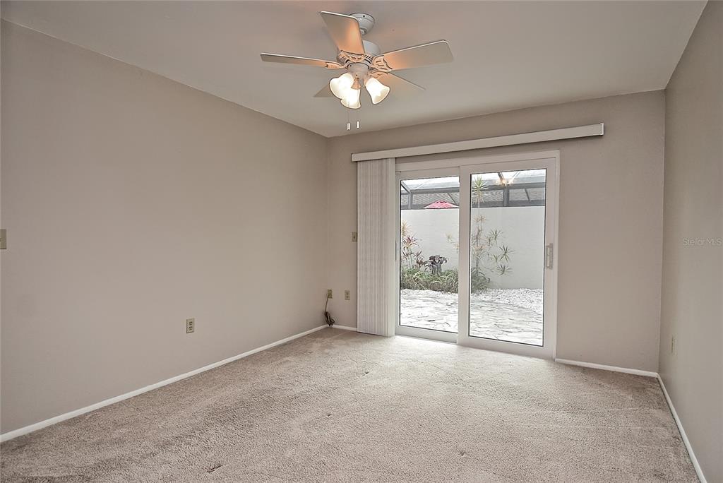 4058 Center Pointe Place, Unit 28A Sarasota, FL 34233 - Photo 10 of 24 an empty room with windows and ceiling fan