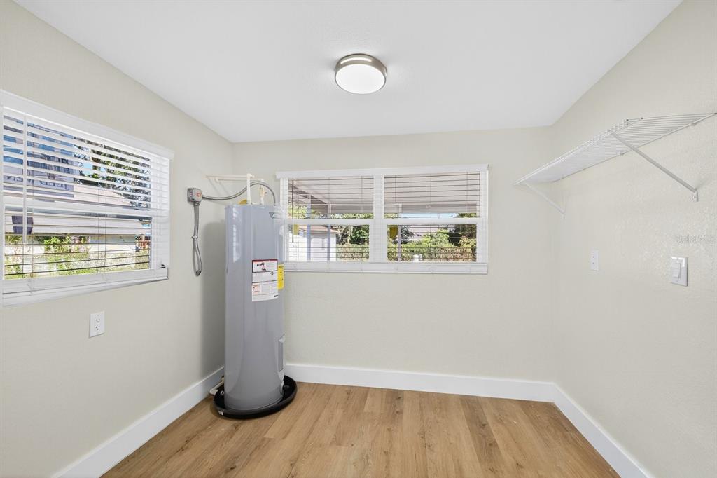 928 Valmar Street Brandon, FL 33511 - Photo 20 of 35 a view of an empty room with wooden floor and a window