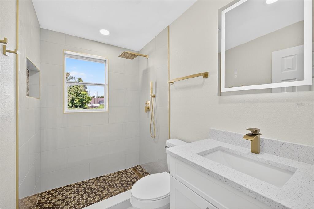 928 Valmar Street Brandon, FL 33511 - Photo 23 of 35 a bathroom with a sink a toilet and shower