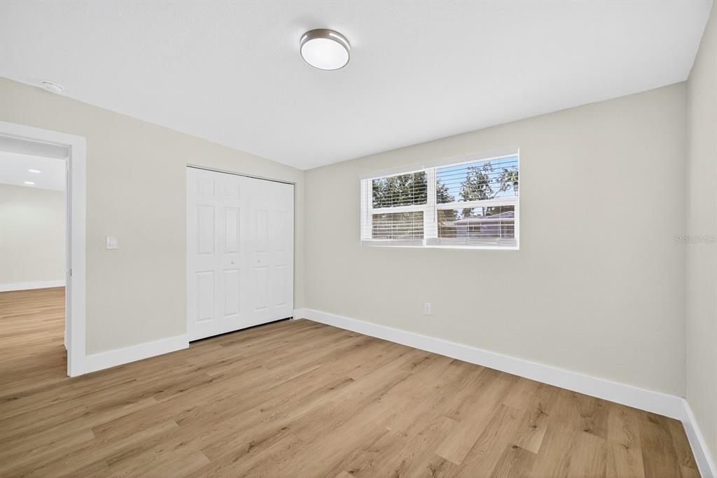 928 Valmar Street Brandon, FL 33511 - Photo 26 of 35 an empty room with wooden floor and windows