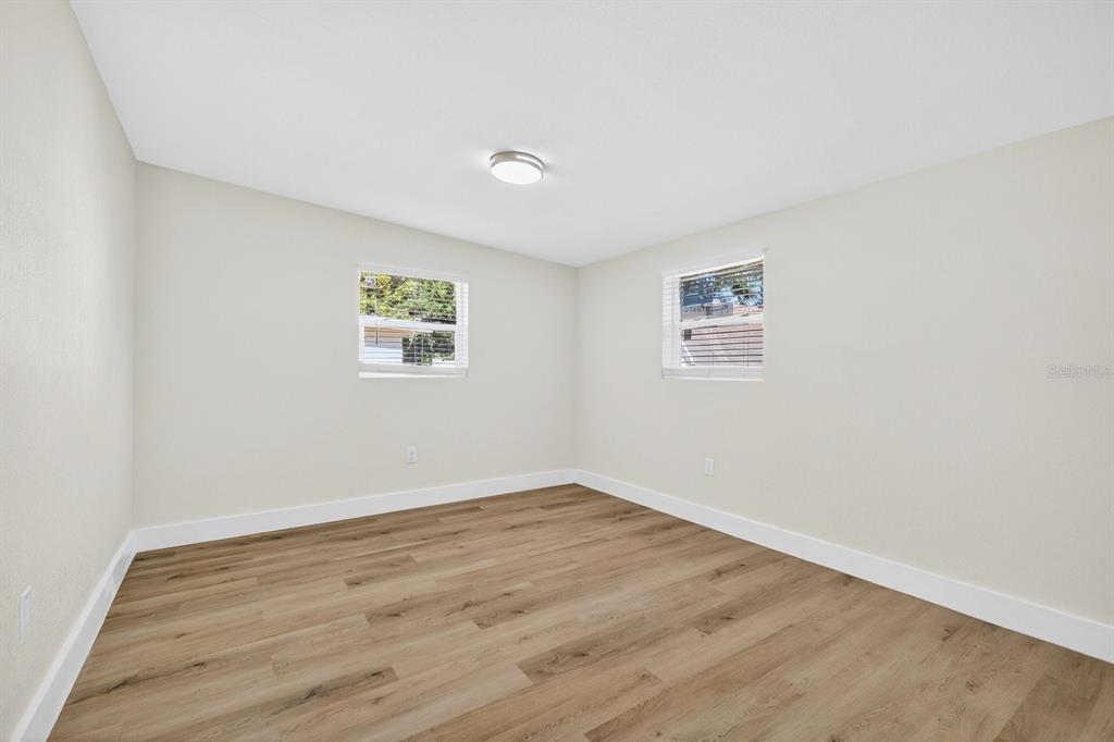 928 Valmar Street Brandon, FL 33511 - Photo 27 of 35 an empty room with wooden floor and windows