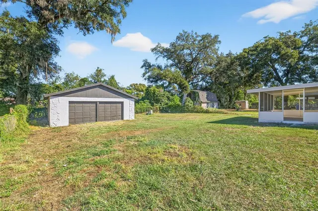 a house with huge green field in front of it