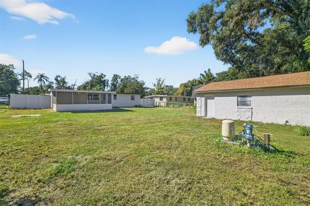 a backyard of a house with table and chairs