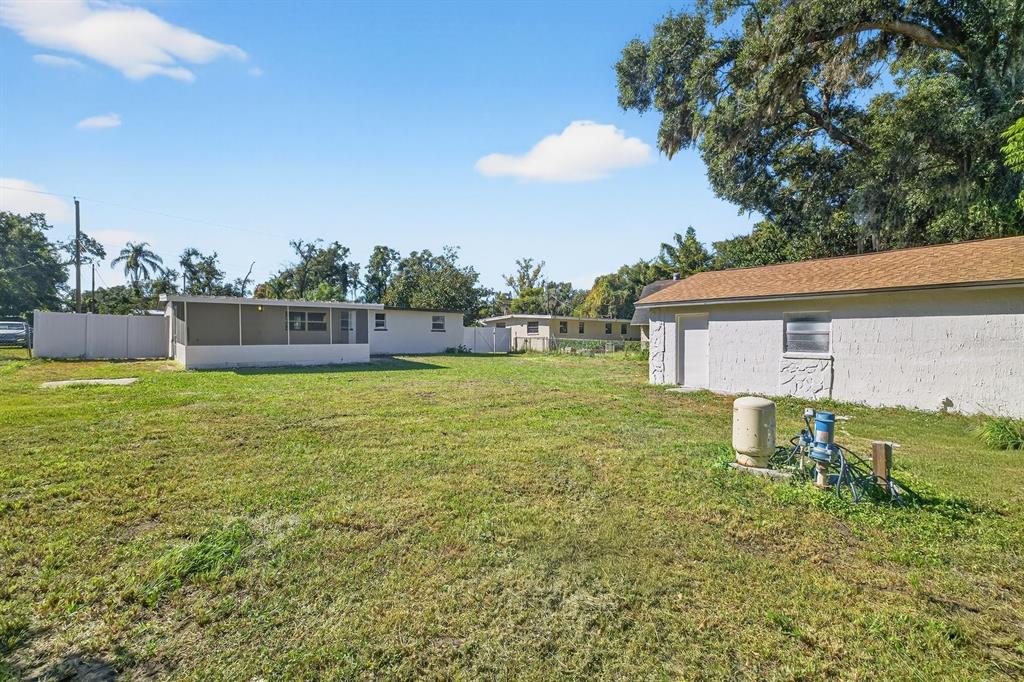 928 Valmar Street Brandon, FL 33511 - Photo 31 of 35 a backyard of a house with table and chairs