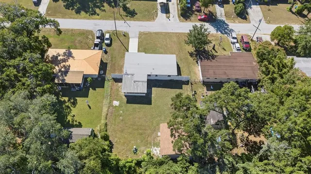 an aerial view of house with swimming pool