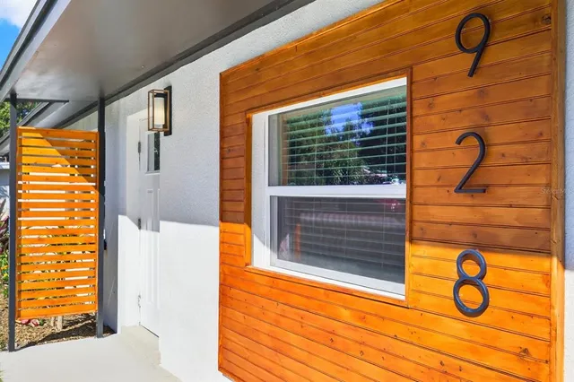 a view of a door and brick walls