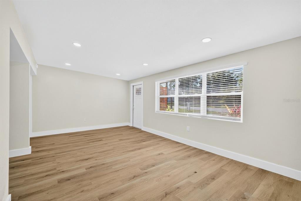 928 Valmar Street Brandon, FL 33511 - Photo 7 of 35 a view of an empty room with wooden floor and a window