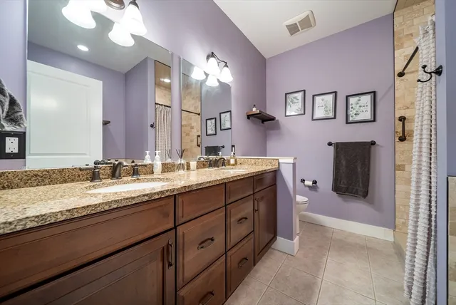 a bathroom with a sink double vanity and a mirror