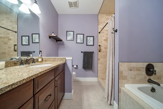 a bathroom with a granite countertop sink a mirror and shower
