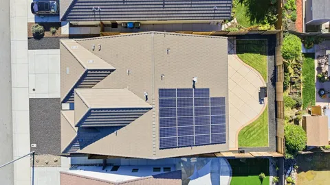 an aerial view of a house with a yard