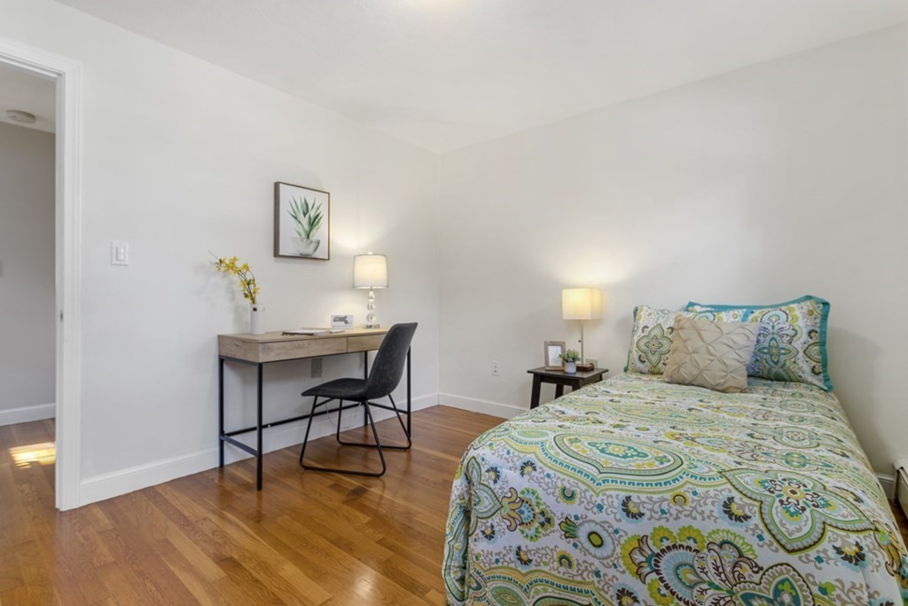 25 Oak Street Reading, MA 01867 - Photo 22 of 42 a bedroom with a bed and a table in it