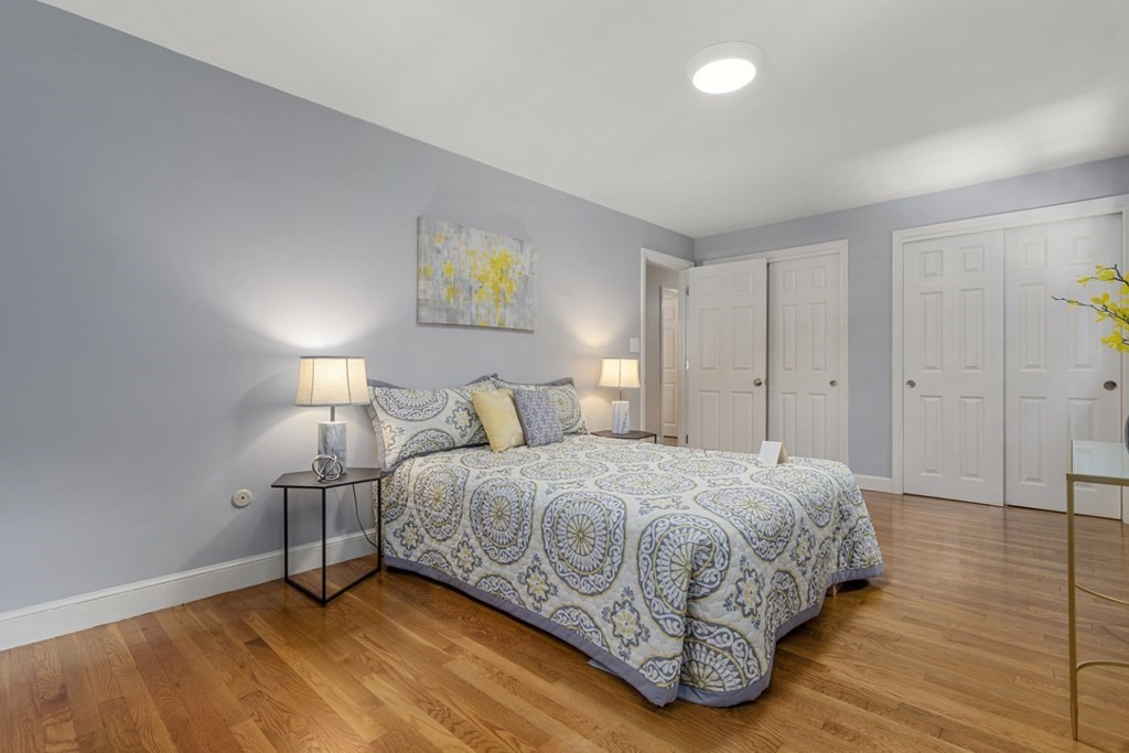 25 Oak Street Reading, MA 01867 - Photo 30 of 42 a bedroom with a bed and painting on the wall