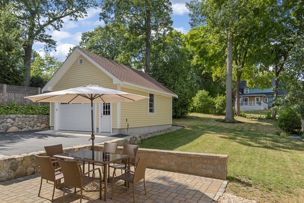 25 Oak Street Reading, MA 01867 - Photo 38 of 42 a view of a yard with a table and chairs under an umbrella