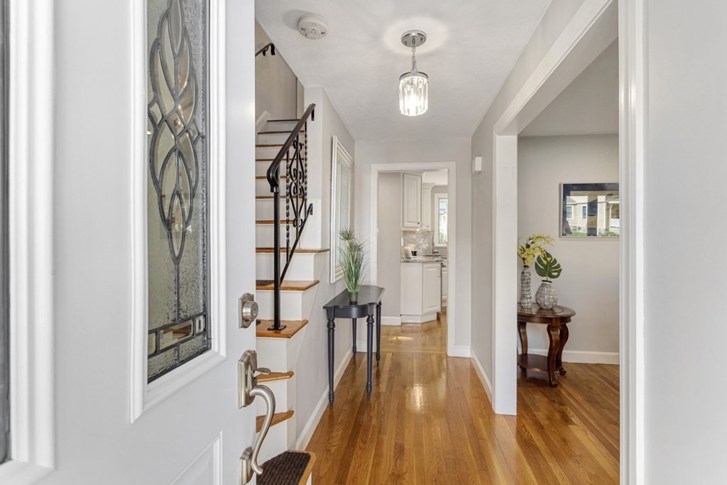 25 Oak Street Reading, MA 01867 - Photo 4 of 42 a view of a hallway with wooden floor and windows