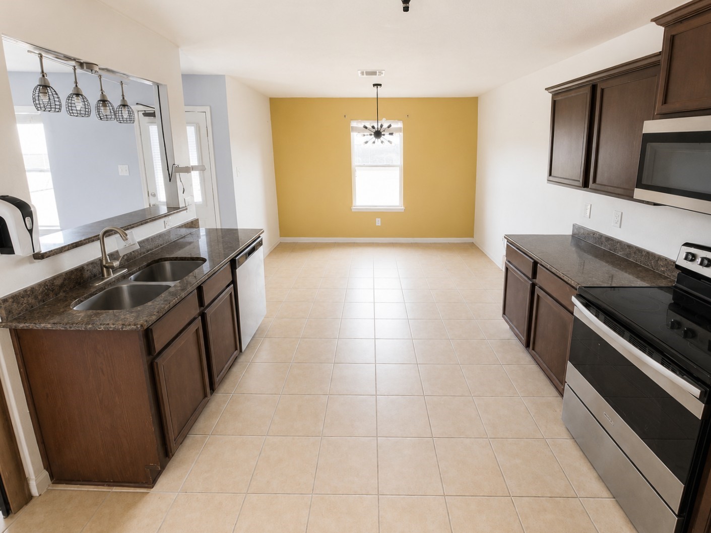 341 Comanche Plains Road La Marque, TX 77568 - Photo 4 of 17 a kitchen with stainless steel appliances granite countertop a sink stove and refrigerator