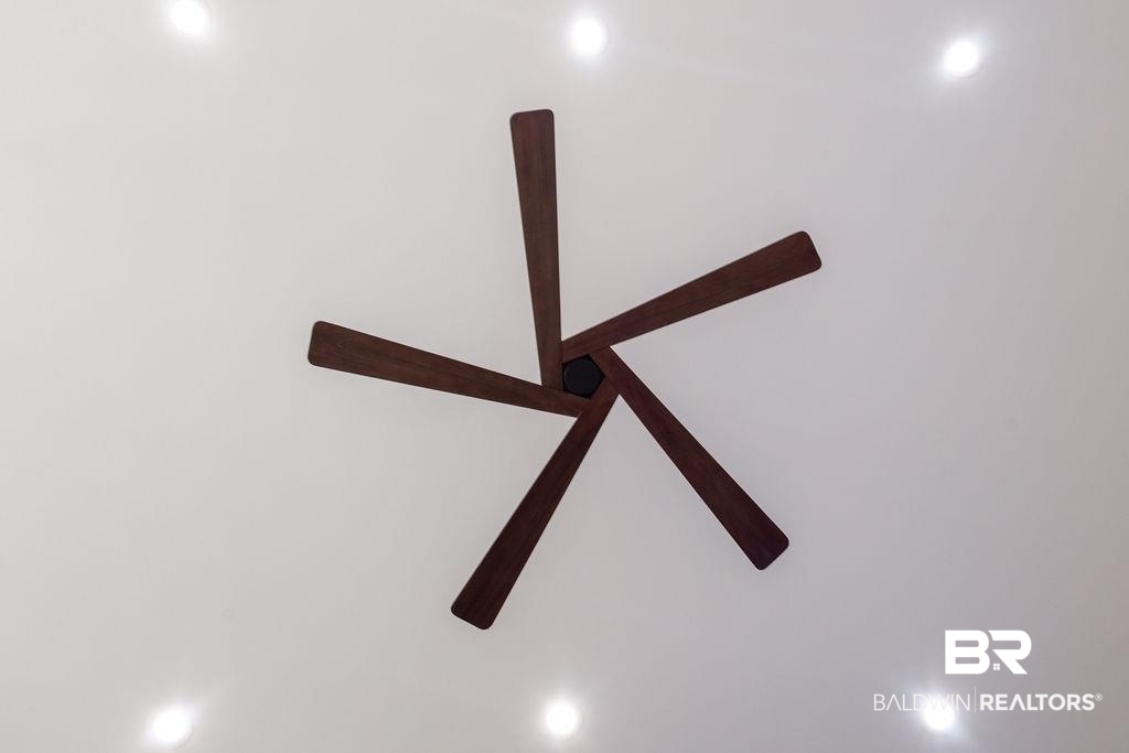 13066 Gopher Court Elberta, AL 36530 - Photo 22 of 38 Modern five-blade ceiling fan in a dark wood finish, complemented by recessed lighting.