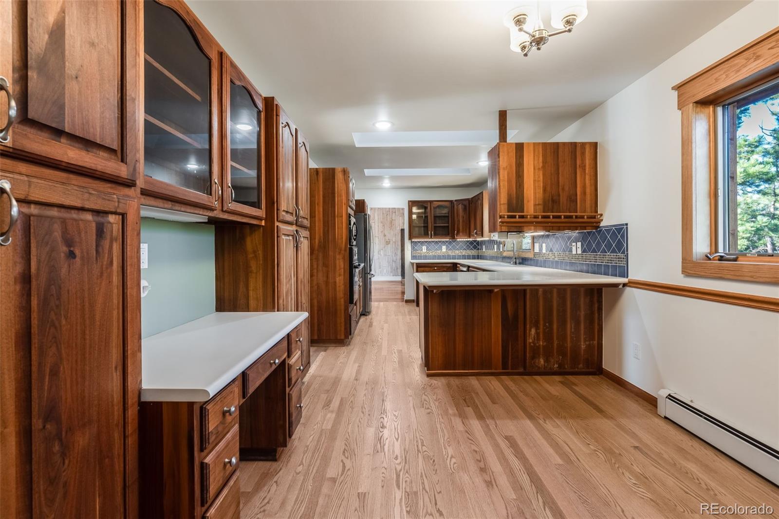 7572 Surrey Drive Morrison, CO 80465 - Photo 11 of 38 a kitchen with stainless steel appliances granite countertop a stove cabinets and wooden floor