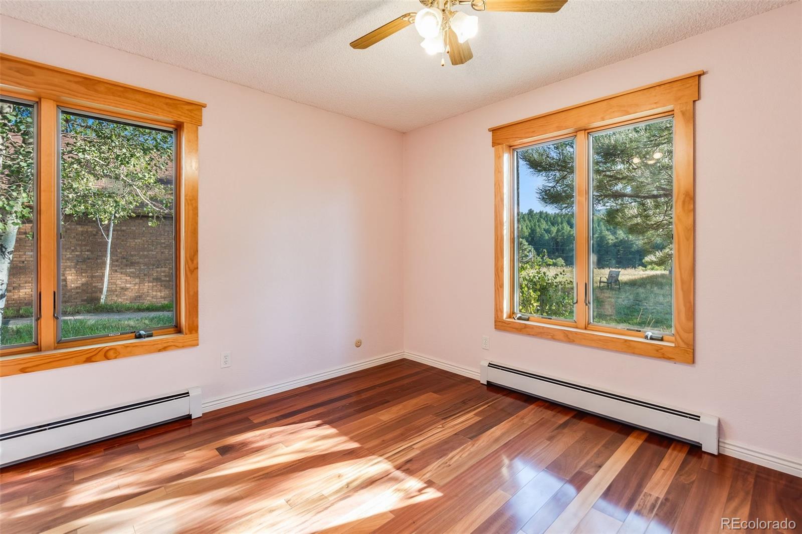 7572 Surrey Drive Morrison, CO 80465 - Photo 17 of 38 a view of an empty room with wooden floor and a window