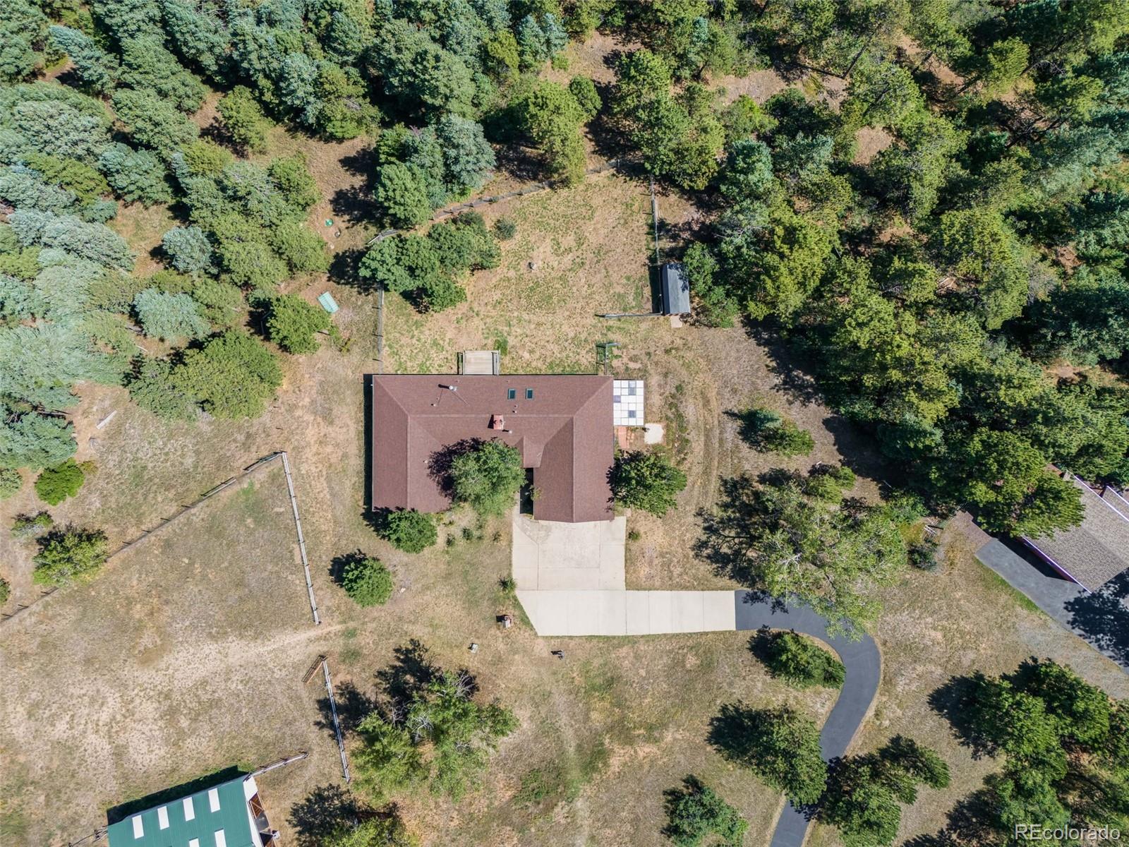 7572 Surrey Drive Morrison, CO 80465 - Photo 29 of 38 an aerial view of a house with a yard