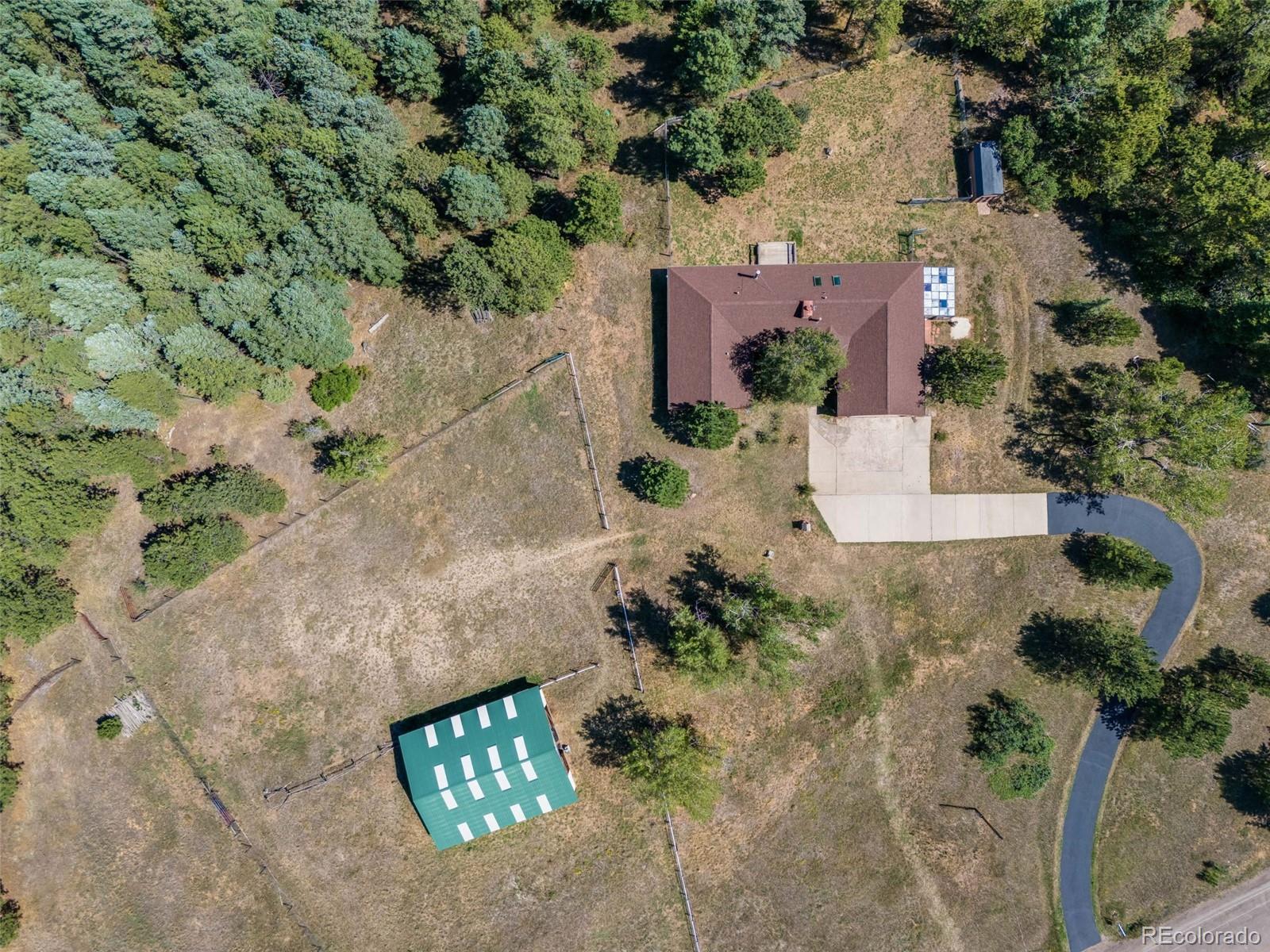 7572 Surrey Drive Morrison, CO 80465 - Photo 32 of 38 an aerial view of a house with a yard and a garden