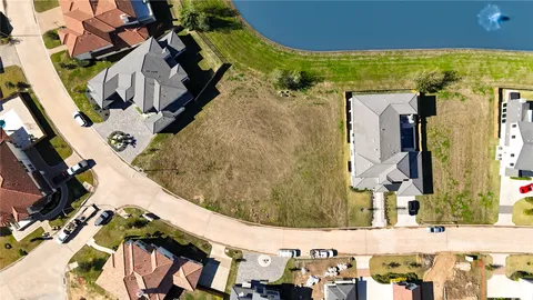 an aerial view of a residential houses with outdoor space and swimming pool
