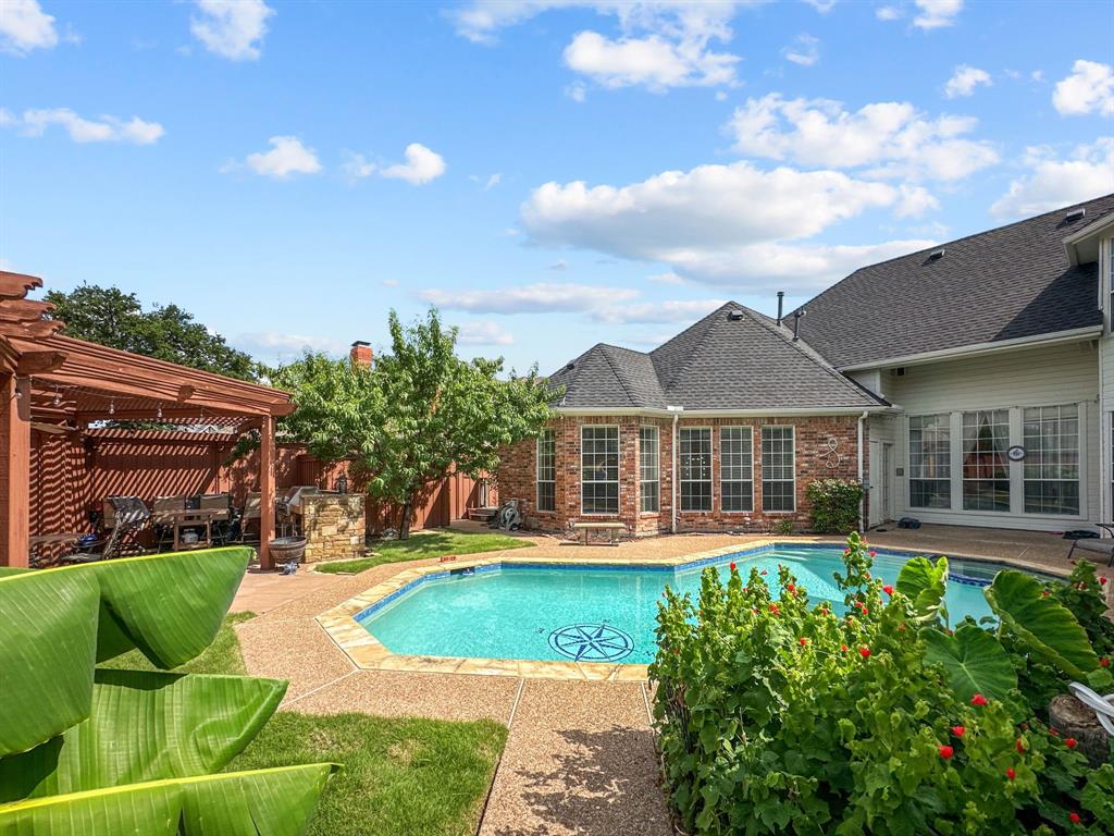 View of swimming pool with a pergola, a patio, and a fenced backyard