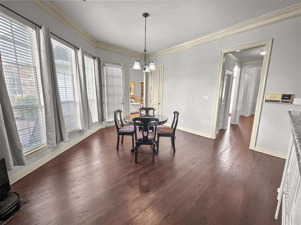 3405 Snidow Drive Plano, TX 75025 - Photo 12 of 24 Dining space featuring a chandelier, dark wood-style flooring, and ornamental molding