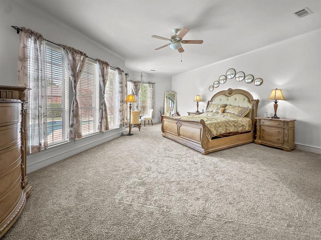 3405 Snidow Drive Plano, TX 75025 - Photo 17 of 24 Carpeted bedroom with ornamental molding and ceiling fan