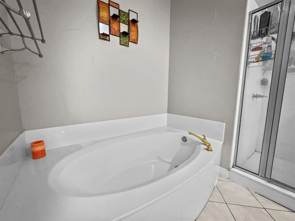 3405 Snidow Drive Plano, TX 75025 - Photo 21 of 24 Bathroom featuring a garden tub, a stall shower, and tile patterned flooring