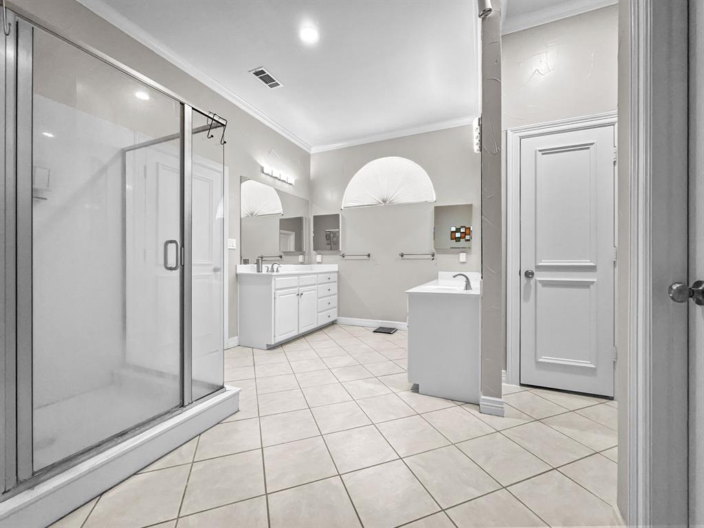 3405 Snidow Drive Plano, TX 75025 - Photo 22 of 24 Bathroom featuring ornamental molding, vanity, a shower stall, and tile patterned floors