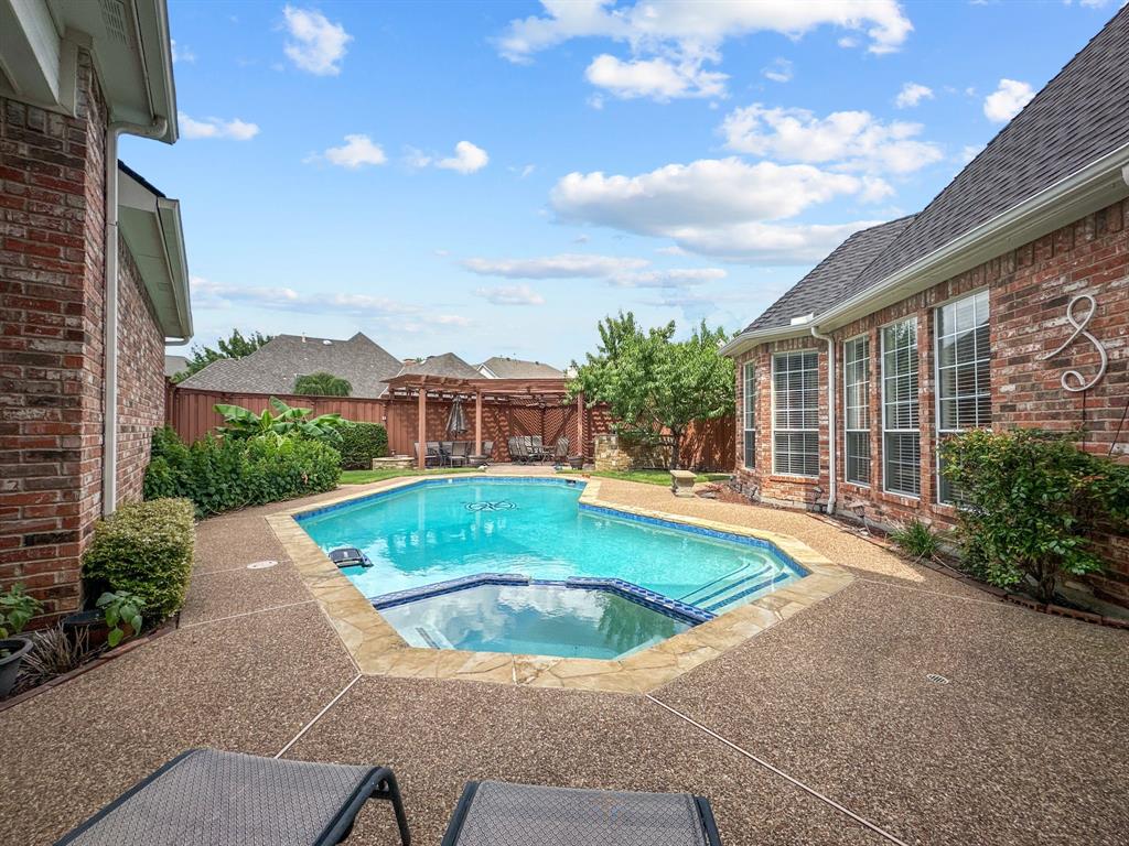 3405 Snidow Drive Plano, TX 75025 - Photo 23 of 24 View of swimming pool featuring a pool with connected hot tub, a fenced backyard, a patio area, and a gazebo