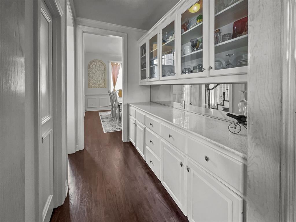 3405 Snidow Drive Plano, TX 75025 - Photo 6 of 24 Bar with dark wood finished floors, a decorative wall, and a wainscoted wall