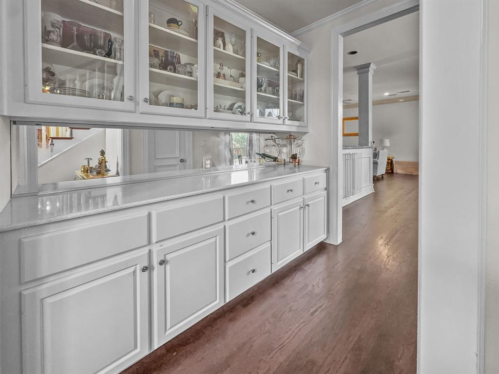3405 Snidow Drive Plano, TX 75025 - Photo 7 of 24 Bar with dark wood-style floors, crown molding, and ornate columns