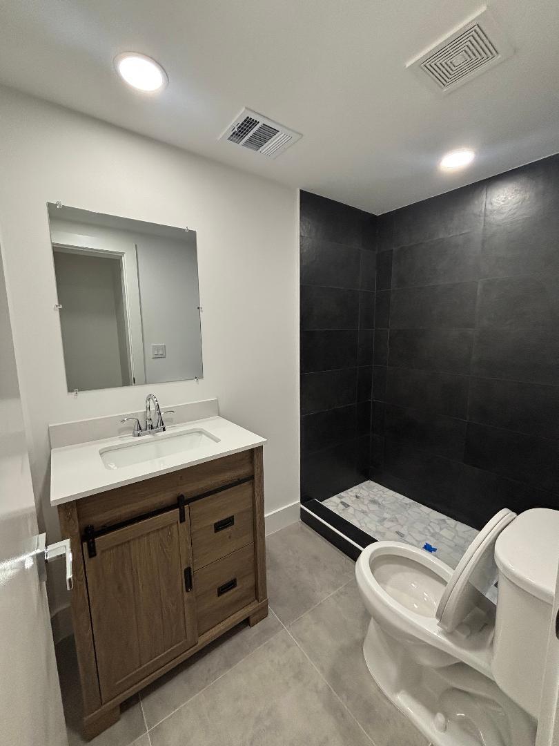 5724 Seton Drive Margate, FL 33063 - Photo 12 of 13 a bathroom with a sink a toilet and a mirror