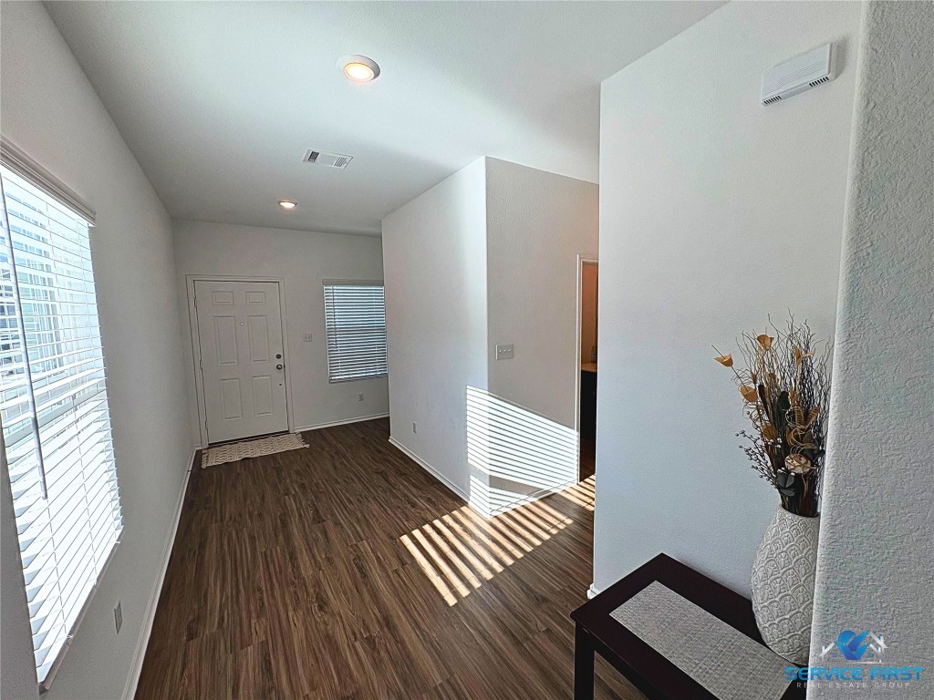 124 Rooster Way Jarrell, TX 76537 - Photo 14 of 27 wooden floor in an empty room with a window