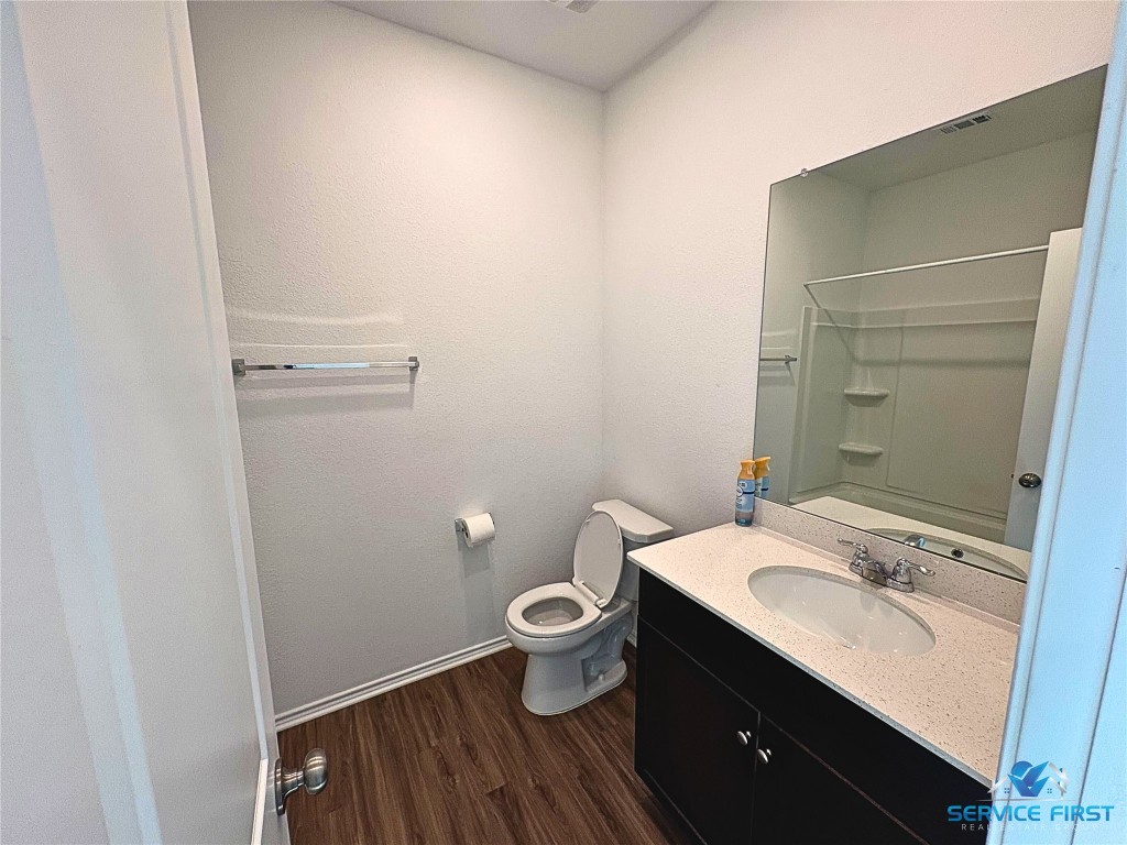 124 Rooster Way Jarrell, TX 76537 - Photo 17 of 27 a bathroom with a granite countertop sink toilet and shower