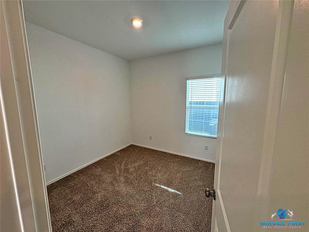 124 Rooster Way Jarrell, TX 76537 - Photo 22 of 27 an empty room with windows