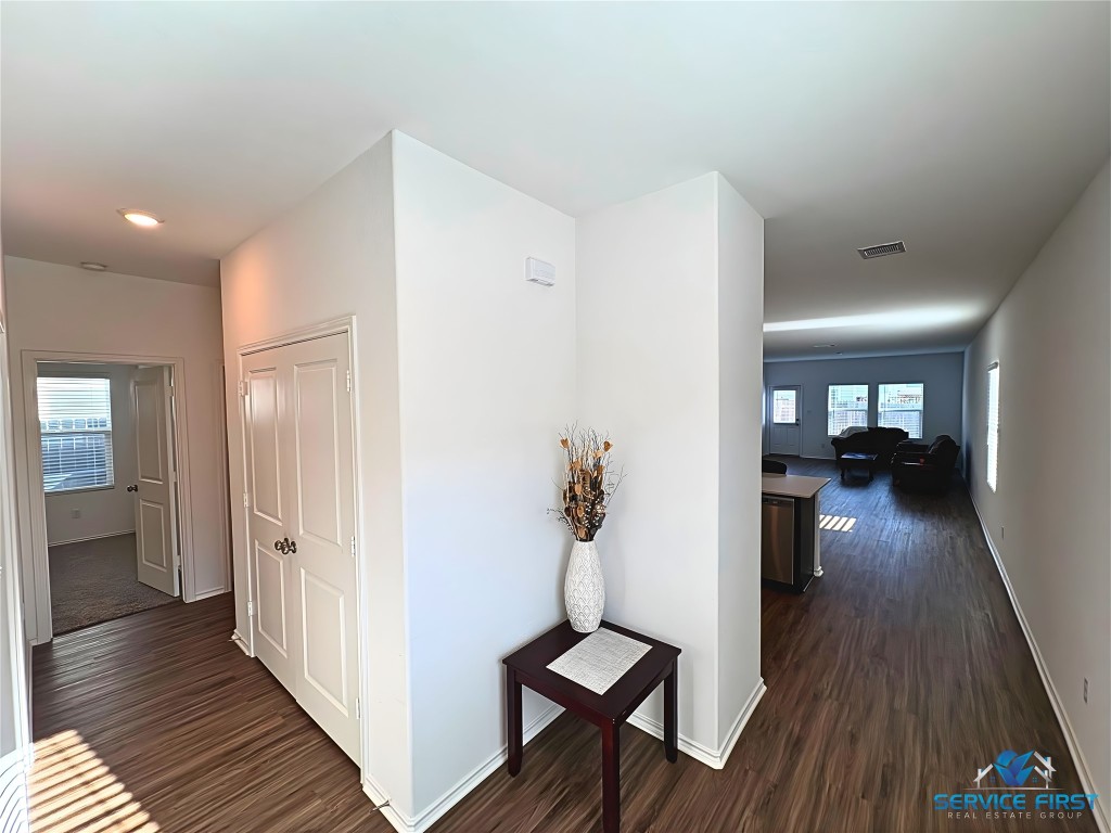 124 Rooster Way Jarrell, TX 76537 - Photo 4 of 27 a view of a hallway view with wooden floor and staircase