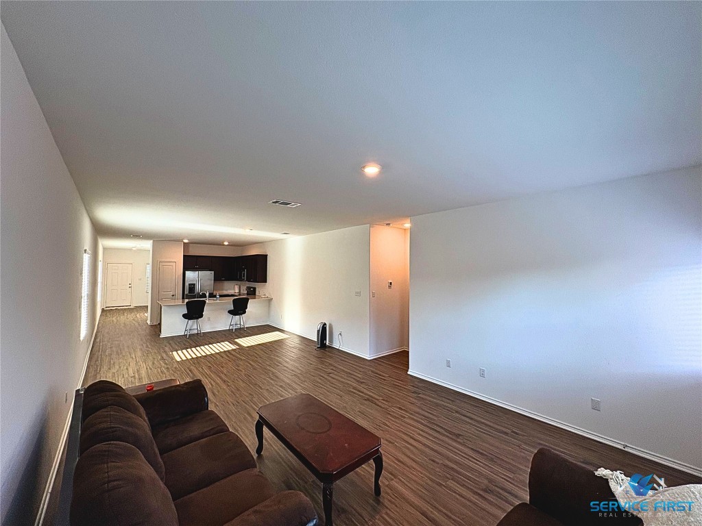 124 Rooster Way Jarrell, TX 76537 - Photo 5 of 27 a living room with furniture and a wooden floor
