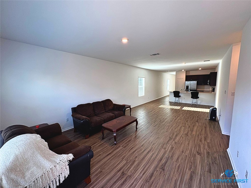 124 Rooster Way Jarrell, TX 76537 - Photo 6 of 27 a living room with furniture and a wooden floor