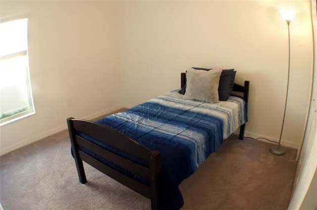 a bedroom with a bed and window