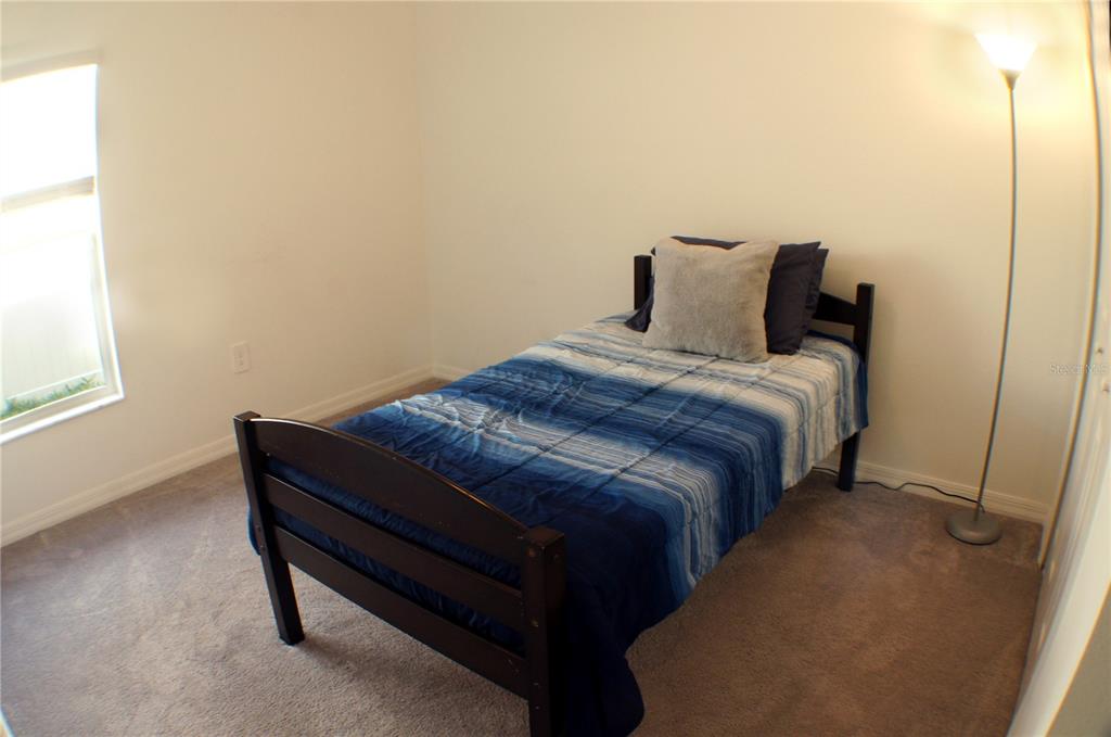 1714 Lanier Road Zephyrhills, FL 33541 - Photo 11 of 23 a bedroom with a bed and window