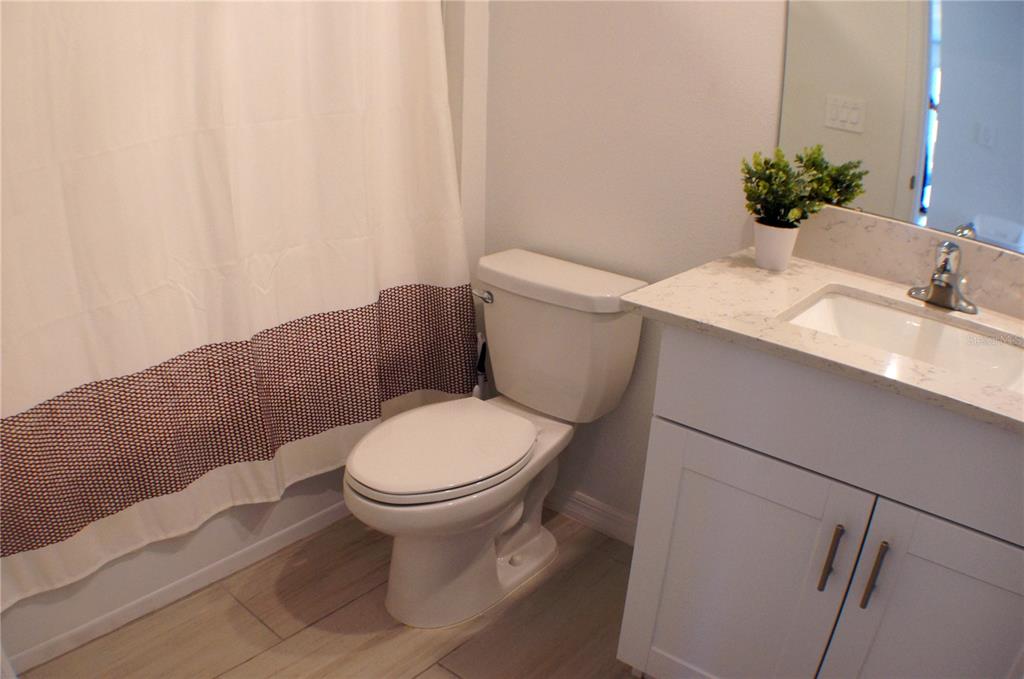 1714 Lanier Road Zephyrhills, FL 33541 - Photo 13 of 23 a white toilet sitting next to a bathroom sink
