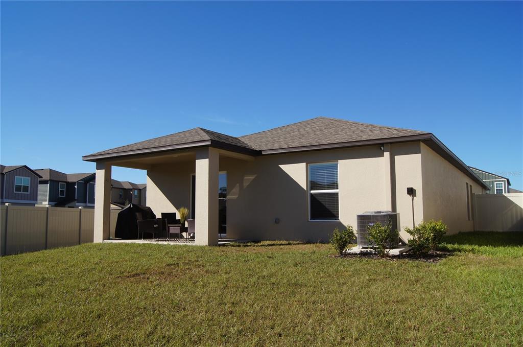1714 Lanier Road Zephyrhills, FL 33541 - Photo 20 of 23 a front view of a house with garden